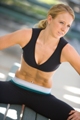 Christa, a personal trainer for women, flexes abdominal (ab) muscles.