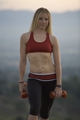 Personal trainer for women - Christa - holds weights outside.