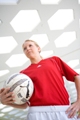 Personal trainer for women - Christa - holds soccer ball and looks motivated.